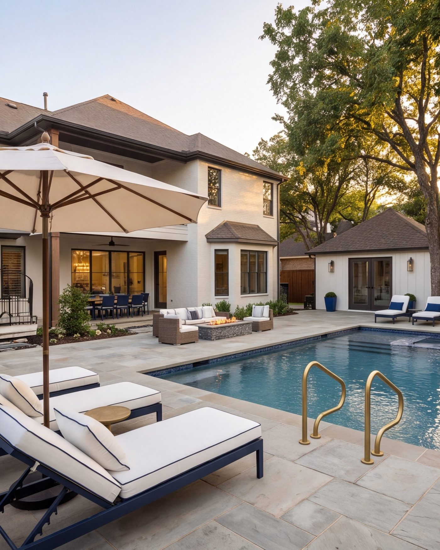 Stone patio and pool deck behind a Dallas home